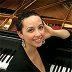 Photo of piano teacher Ana Maria Gomez Ferstl with piano.