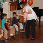 Photo of guitar teacher Erin Johnson with guitar student.