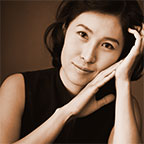 Photo of piano teacher Dr. Heejung Jackson with piano student.