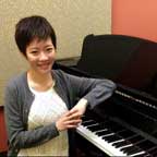 Photo of piano teacher Baoyi Zeng with Piano student.